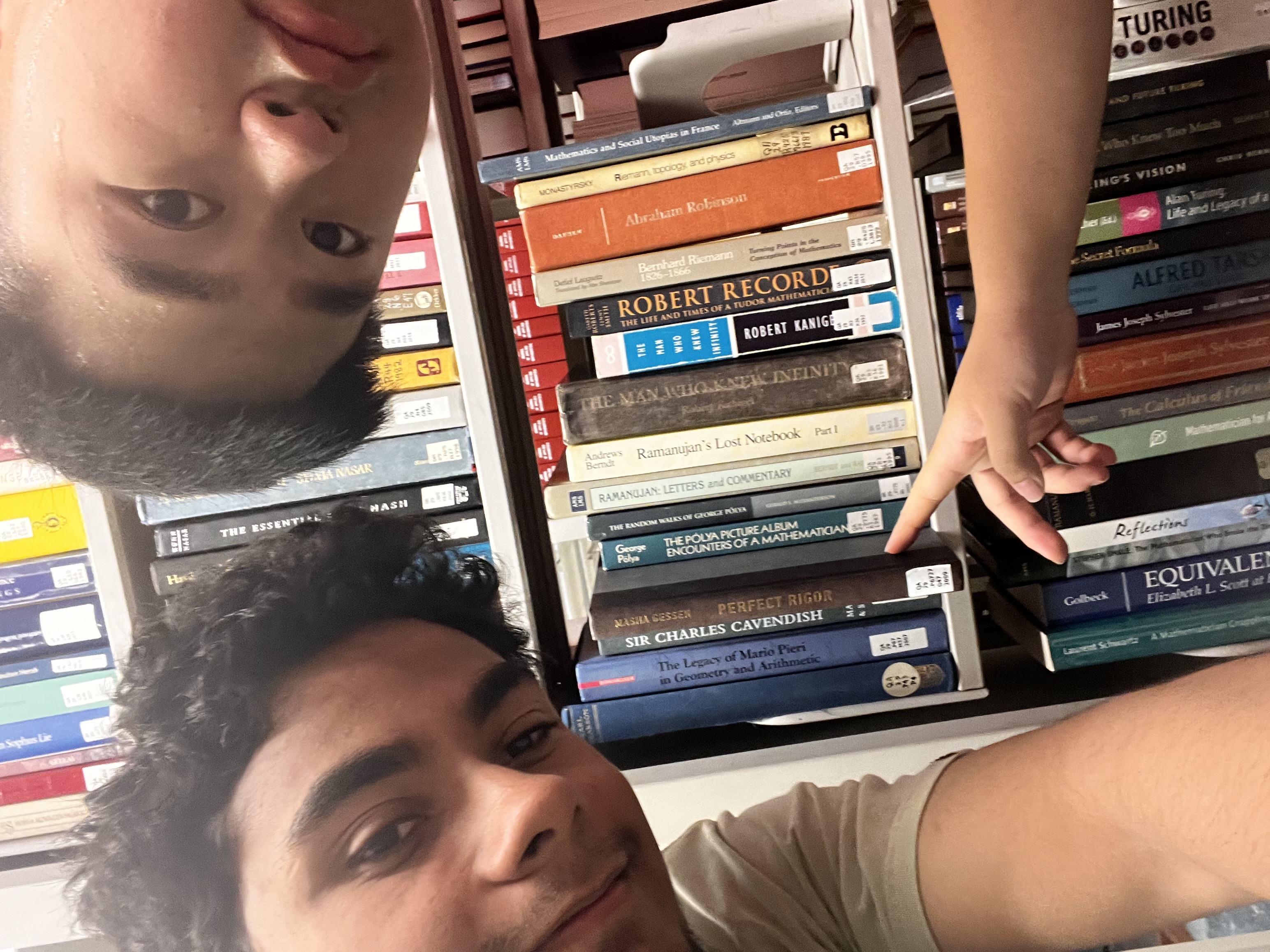 students pointing at books