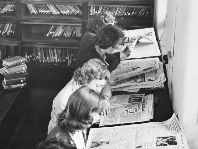 ladies reading newspapers