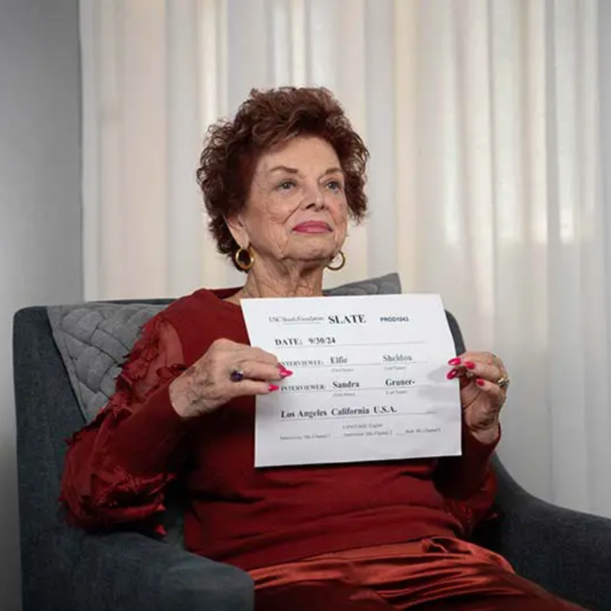 Female interview subject holding a piece of paper