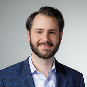 Head shot of Sean Smith against gray background.