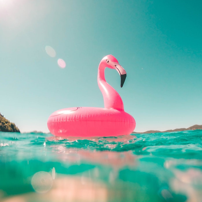 vicko-mozara-m82uh_vamhg-unsplash_0.jpg pink flamingo pool float in blue water